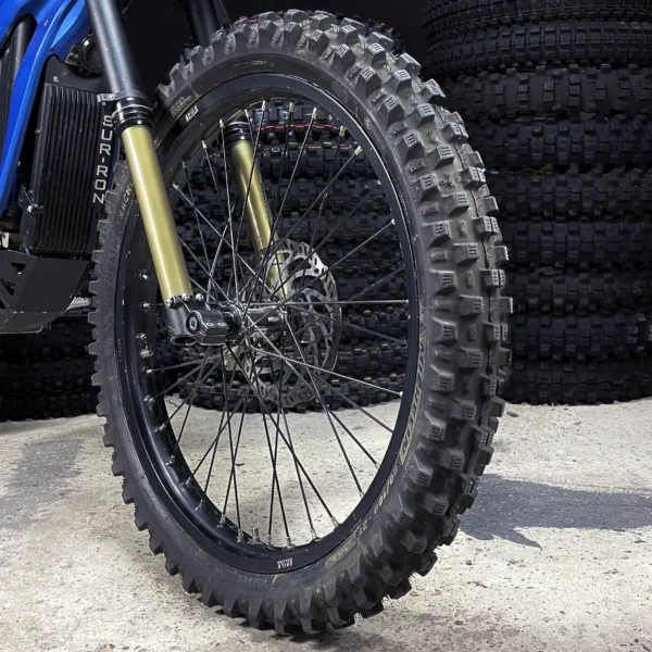 The 21” front wheel is mounted on a Surron e-bike with OFF-ROAD tires.