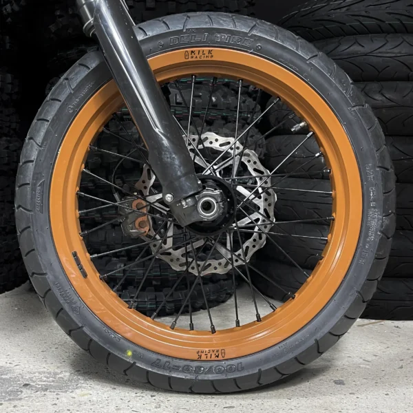 The 17” Supermoto front wheel is mounted on a Surron Ultra Bee e-bike with ON-ROAD tires.