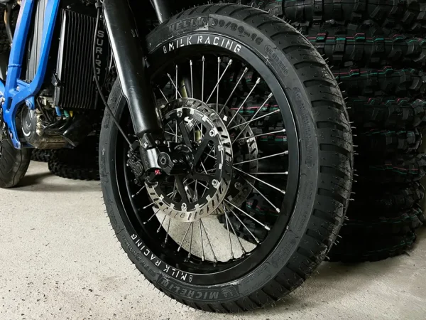 The 16" SuperMoto front wheel is mounted on a Surron e-bike with ON-ROAD tires.
