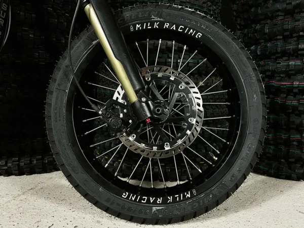 The 16" SuperMoto front wheel is mounted on a Surron e-bike with ON-ROAD tires.