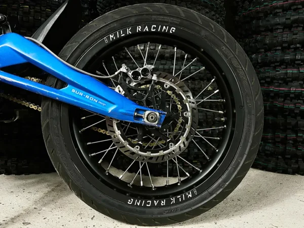 The 16" SuperMoto rear wheel is mounted on a Surron e-bike with ON-ROAD tires.