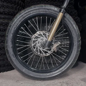 The 18" SuperMoto front wheel is mounted on a Surron e-bike with ON-ROAD tires.